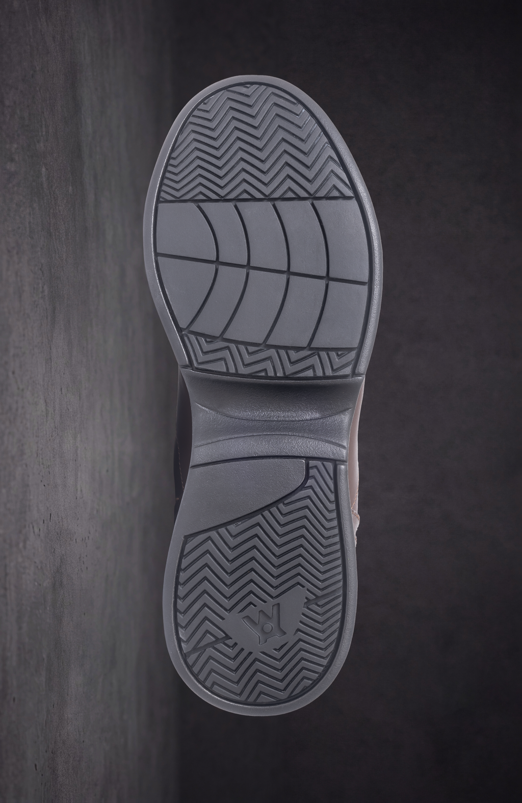 WOA boot outsole tread view with zigzag pattern and grid traction grooves