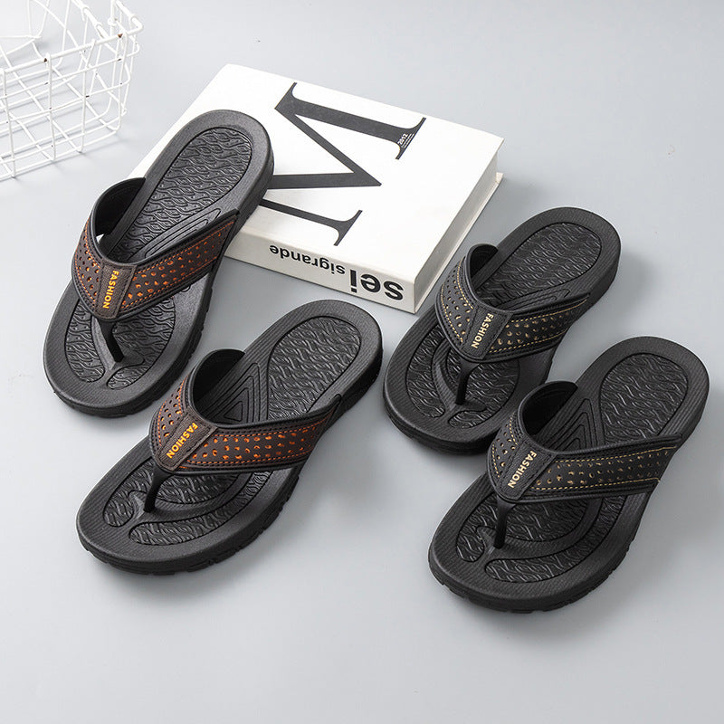 Black men’s flip-flop sandals with orange perforated strap, side view, textured outsoles