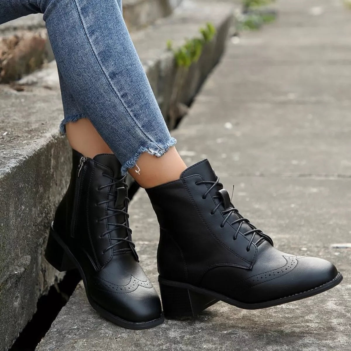 Black lace-up ankle boots with side zipper, wingtip-style toe and block heel