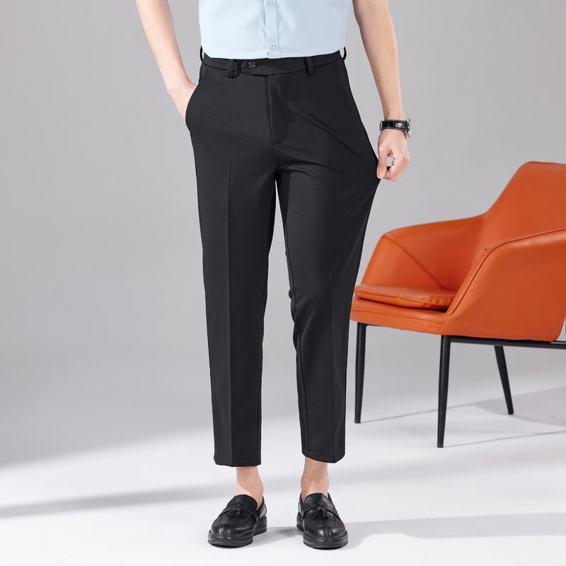 Black business trousers with belt loops and ankle-length straight tapered legs