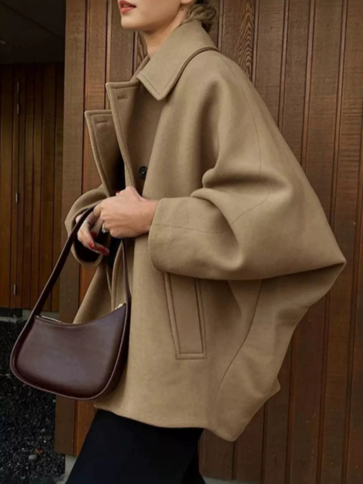 Khaki button-up coat with notched collar, structured shoulders, and long sleeves