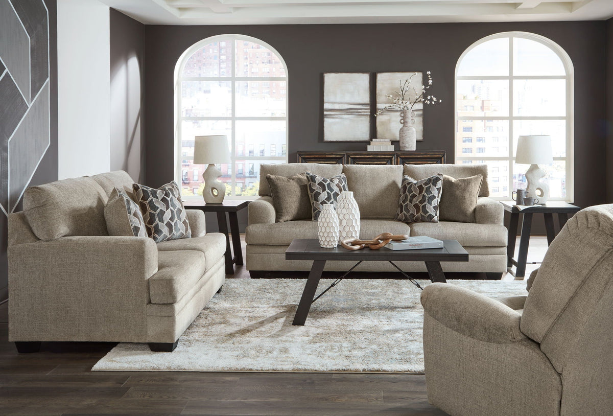 Light brown fabric living room set with sofa, two armchairs, and patterned pillows
