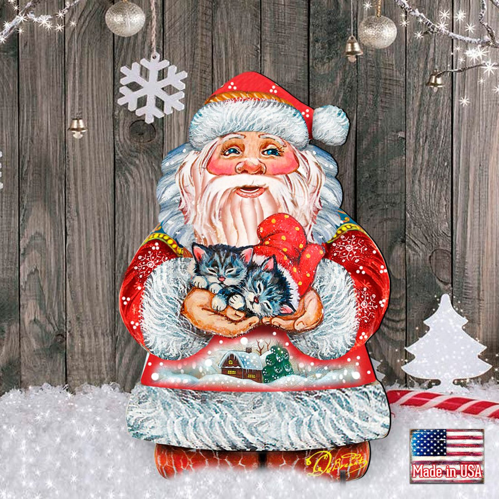 Santa holding a kitten yard sign with red suit and white fur, against a wood backdrop