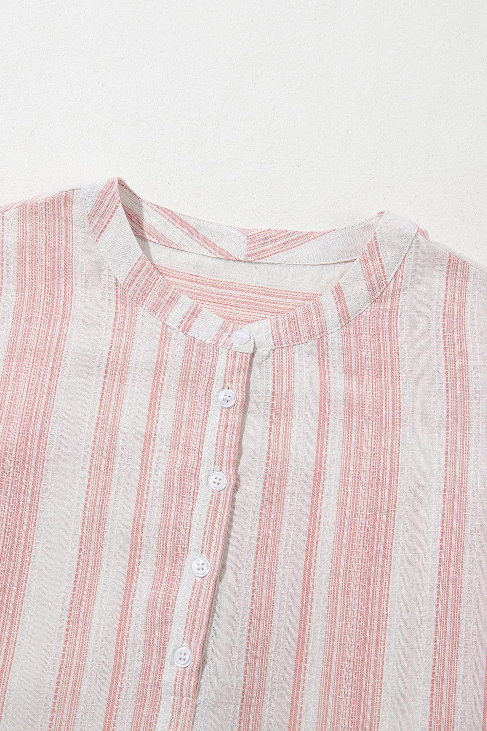 Dusty pink striped short-sleeve blouse with button placket and rounded neckline