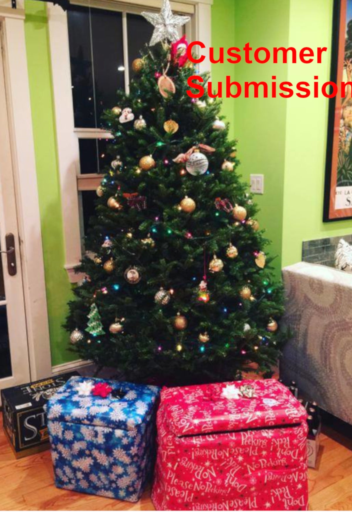 Decorated indoor balsam fir Christmas tree with ornaments and wrapped gifts