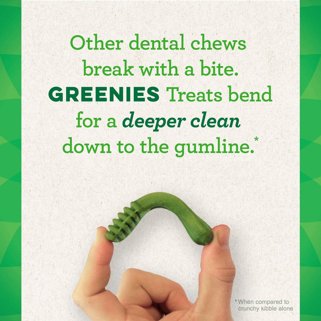 Greenies green ribbed dental chew in hands, U-shaped for dog teeth