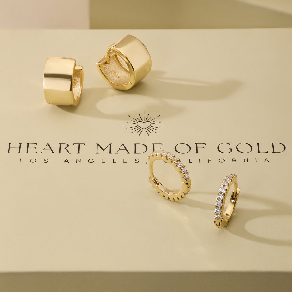 Gold hoop earrings set with two chunky hoops and two rhinestone hoops