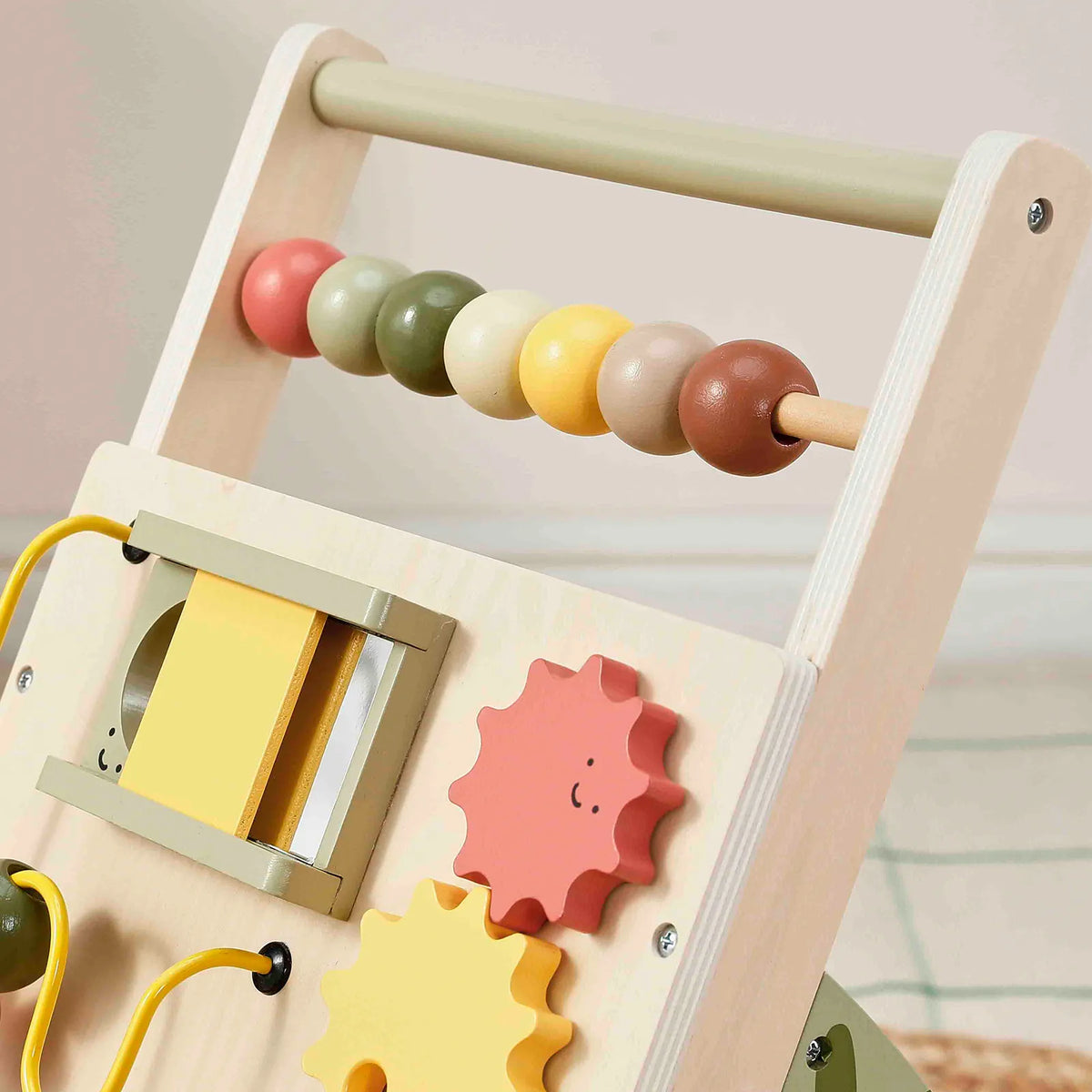 Close-up of wooden baby walker bead roller and side activity door with gear pieces