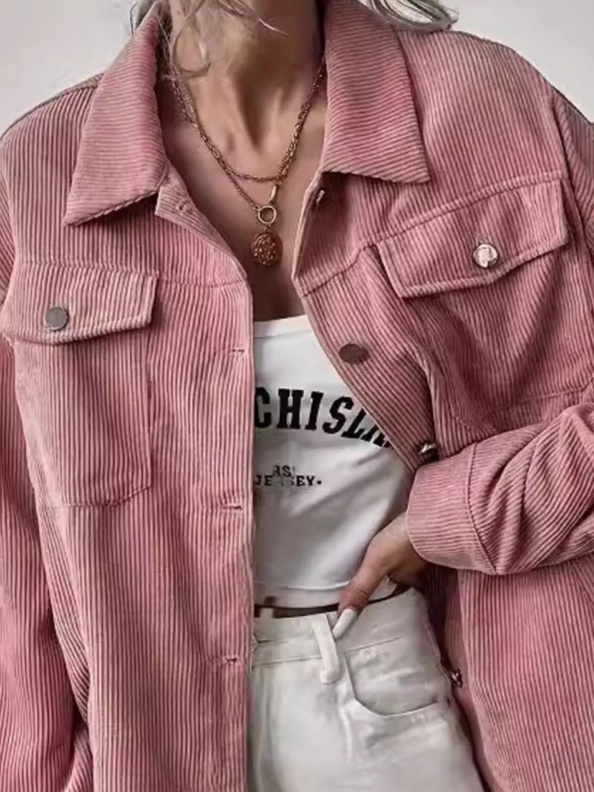 Pink corduroy shacket detail with flap chest pockets and button cuffs
