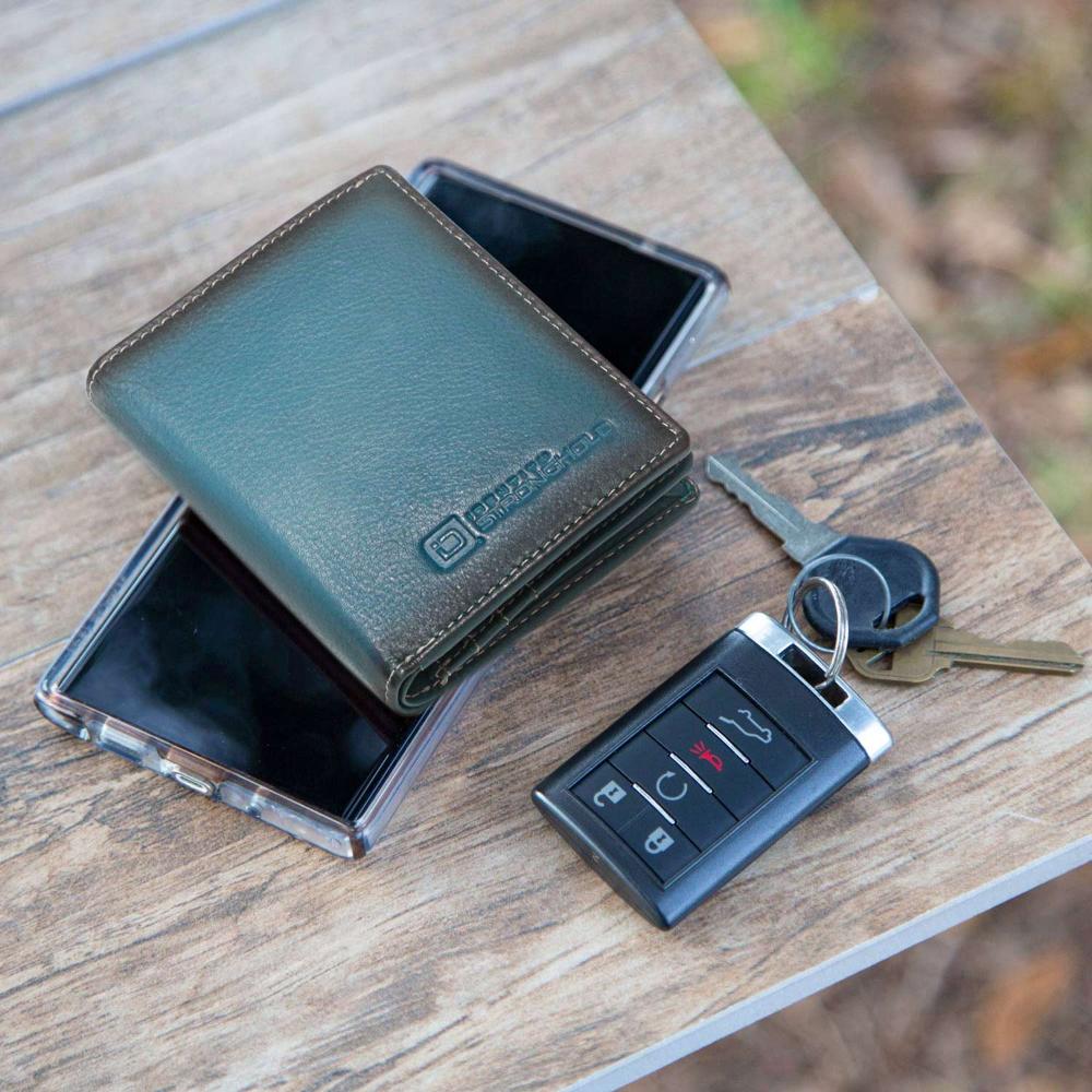 RFID minimalist wallet in dark teal leather with coin pocket detail, beside keys and cards.