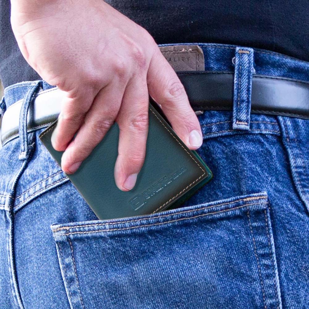 RFID minimalist wallet in dark teal leather, held in a hand with metal edge trim.