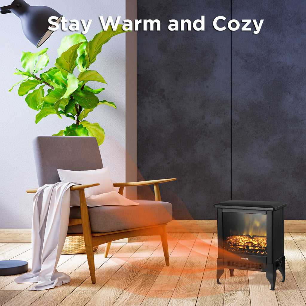 Small black electric fireplace stove heater on the floor with glowing flames behind glass