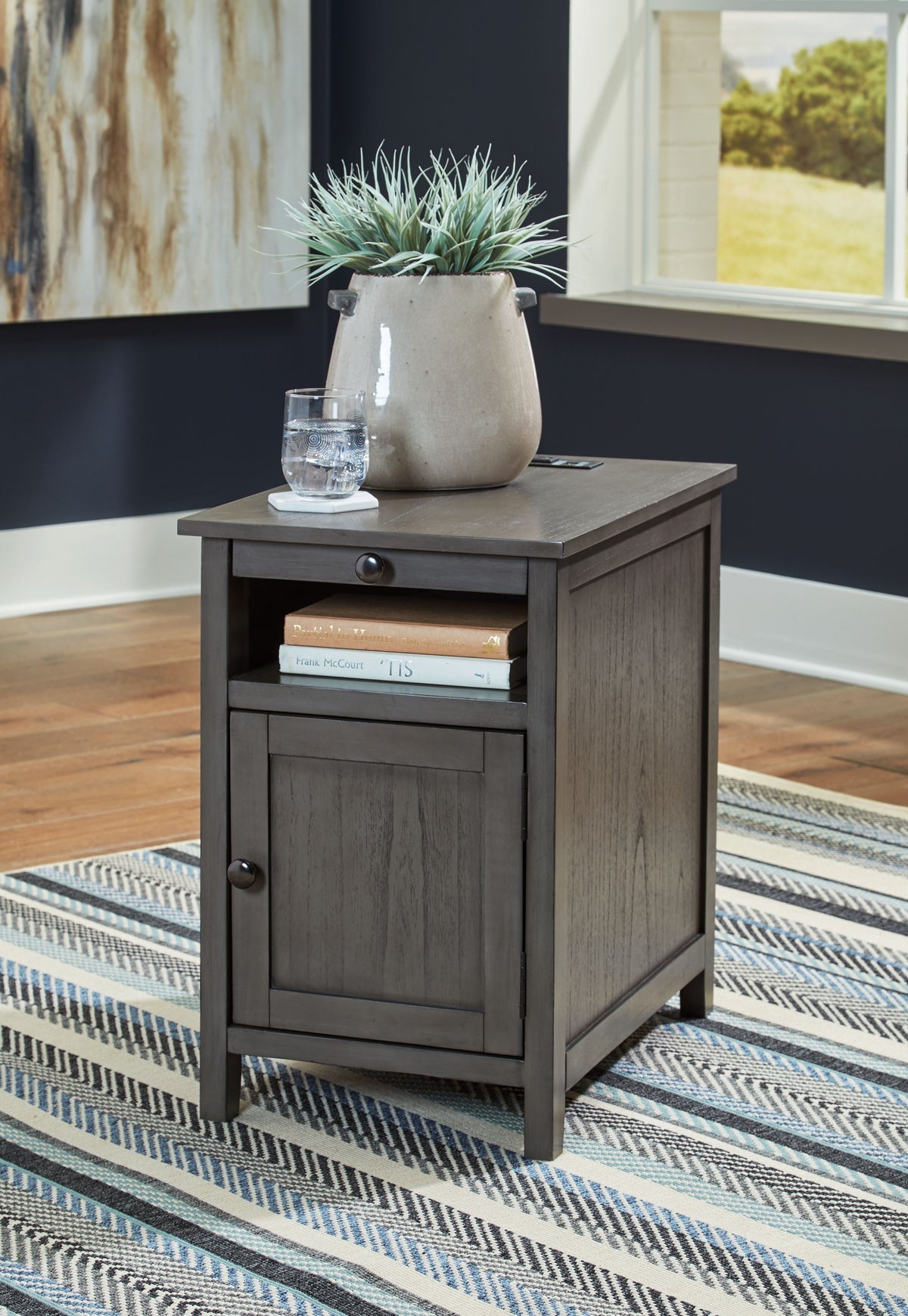 Chair side end table in dark wood with drawer, lower cabinet, and square tapered legs