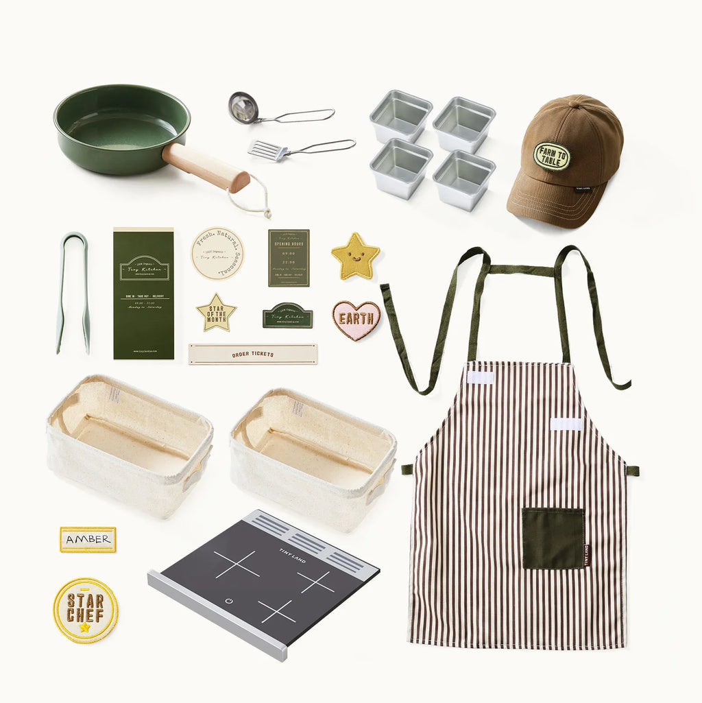 Play kitchen accessory set with green pan, utensils, striped apron, cap, and recipe cards.