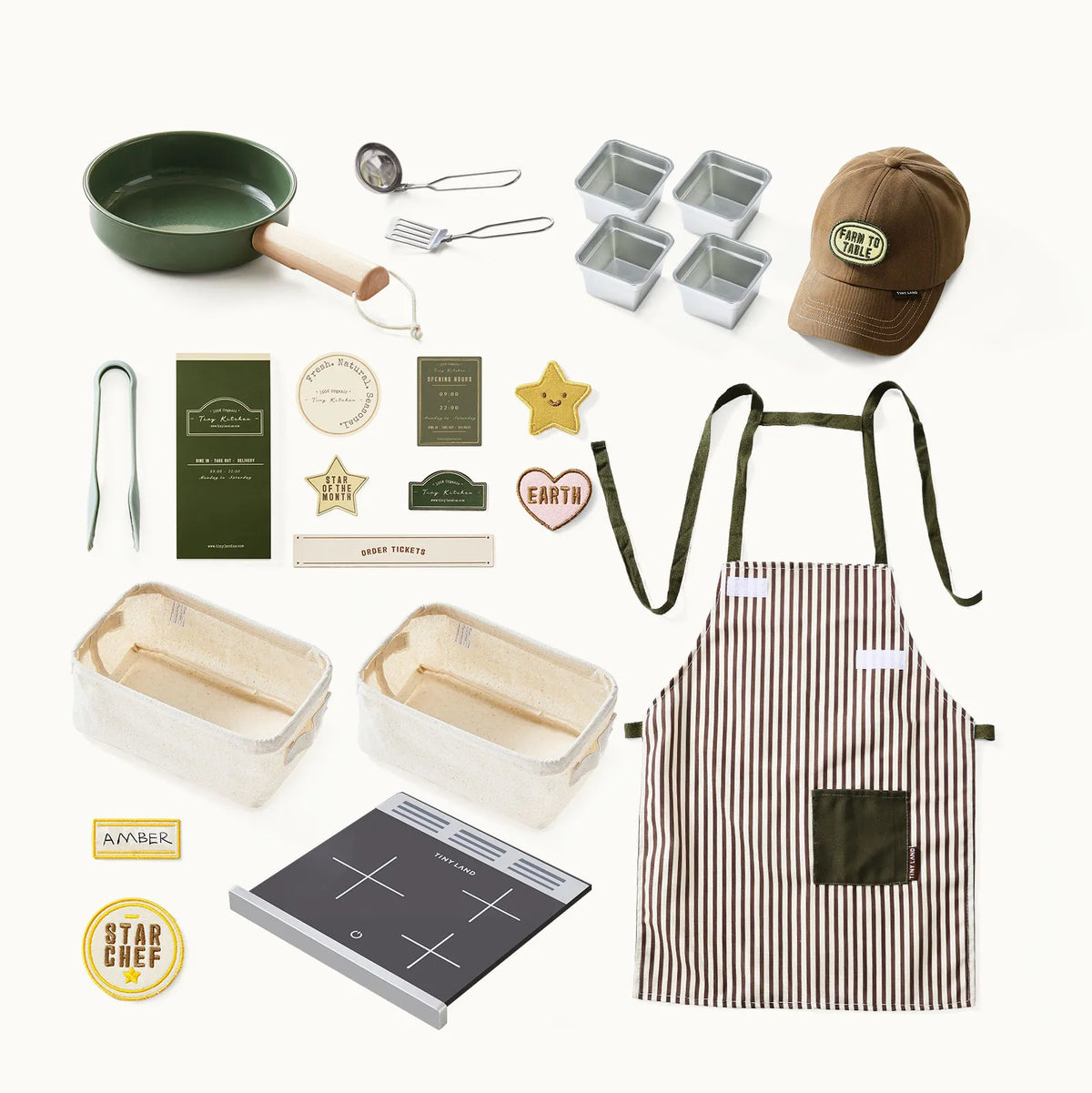 Play kitchen accessory set with green pan, utensils, striped apron, cap, and recipe cards.