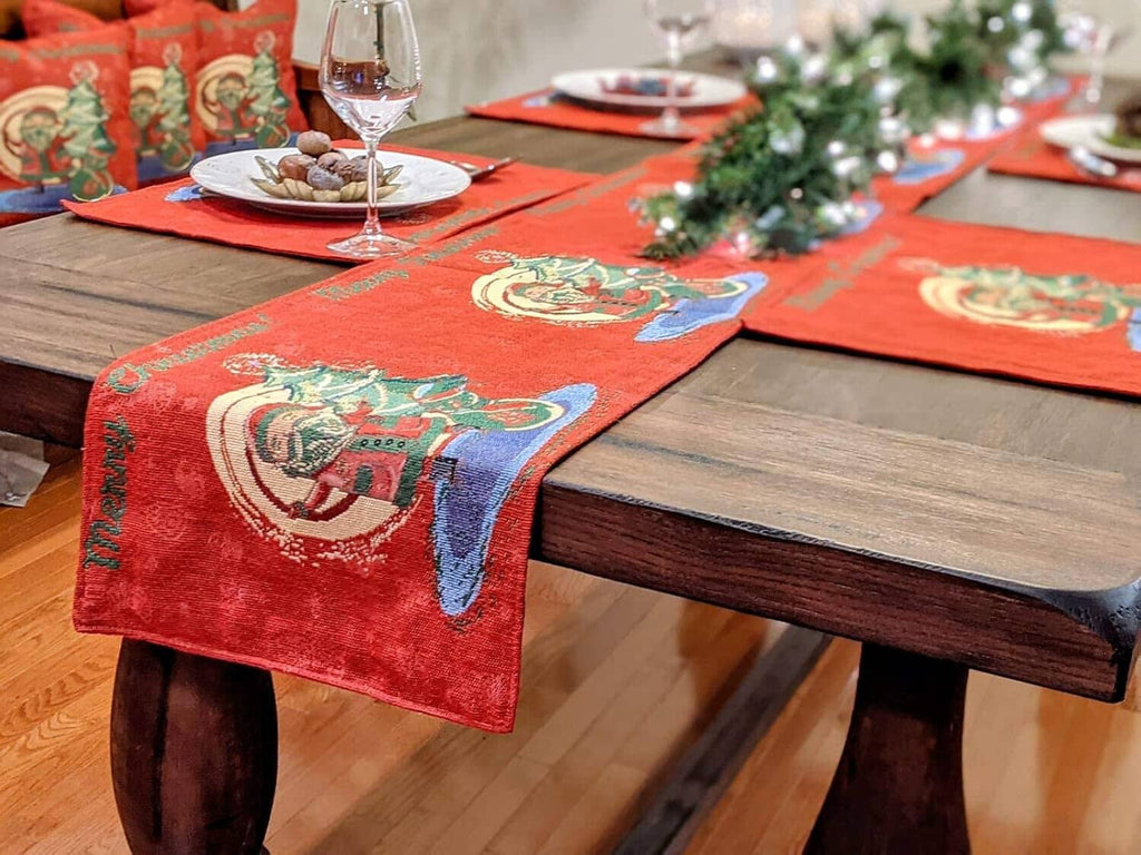 Red woven tapestry dining runner with Santa graphic on a dining table