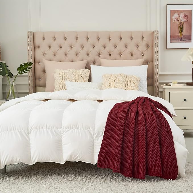 Burgundy chunky cable-knit throw blanket folded on a bed
