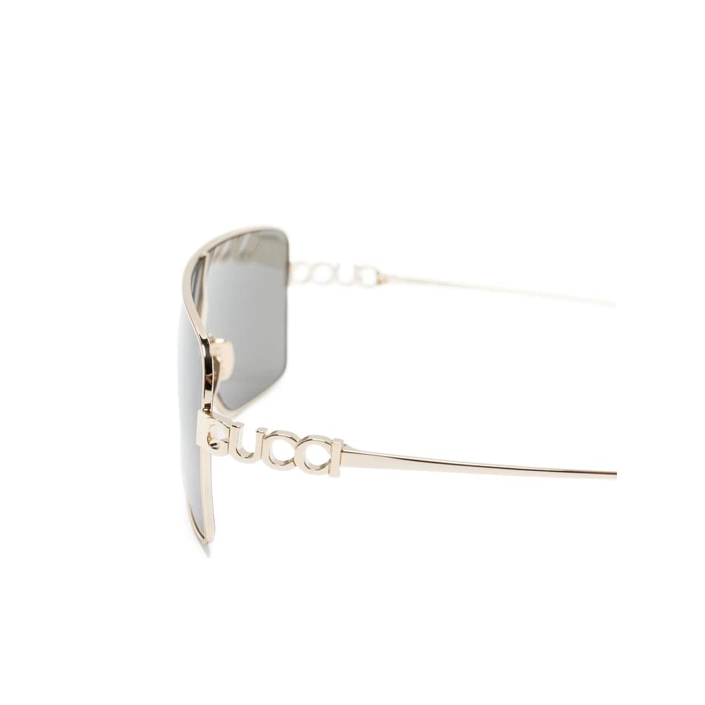 Gucci gold-tone sunglasses side view with engraved logo chain temple