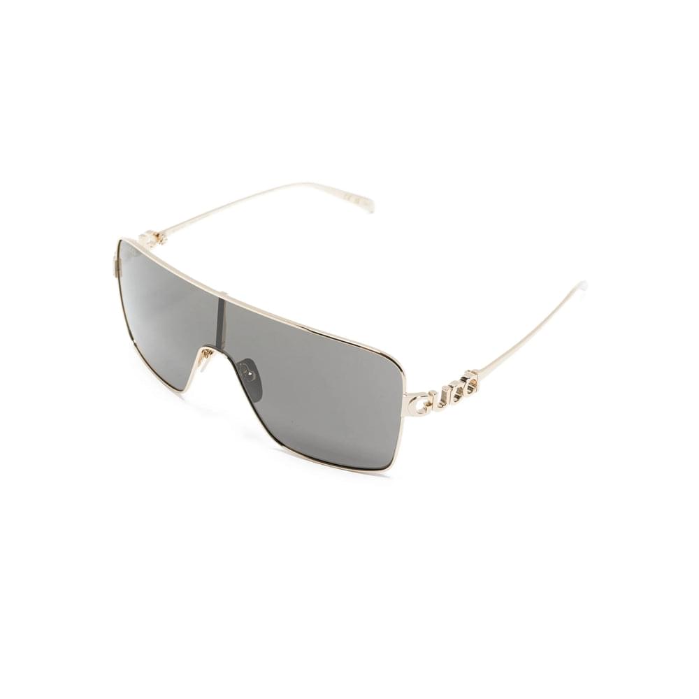 Gucci gold-tone sunglasses angled view with dark lenses and thin metal frame