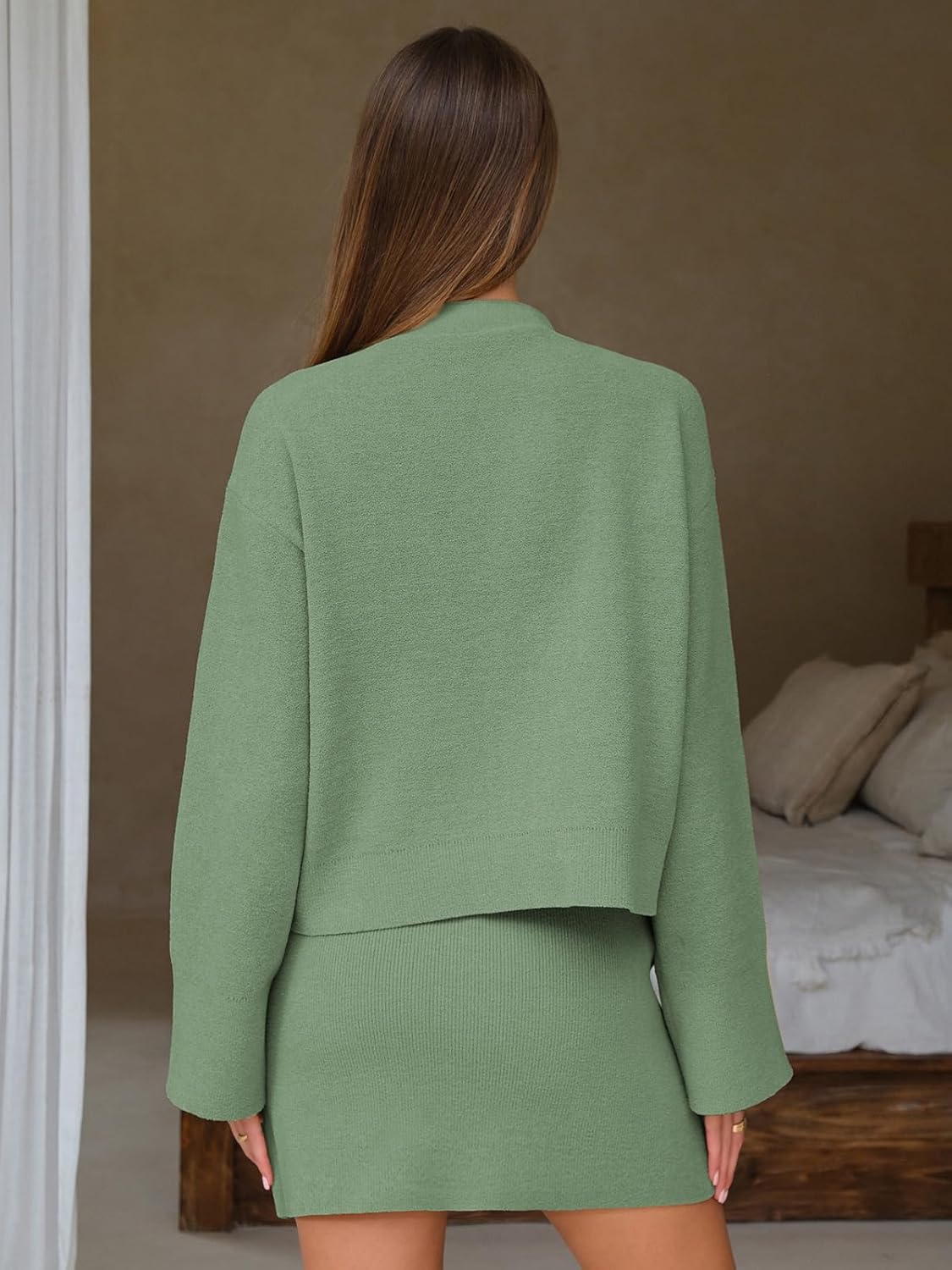 Green knit cardigan and mini skirt from back view, V-neck button closure