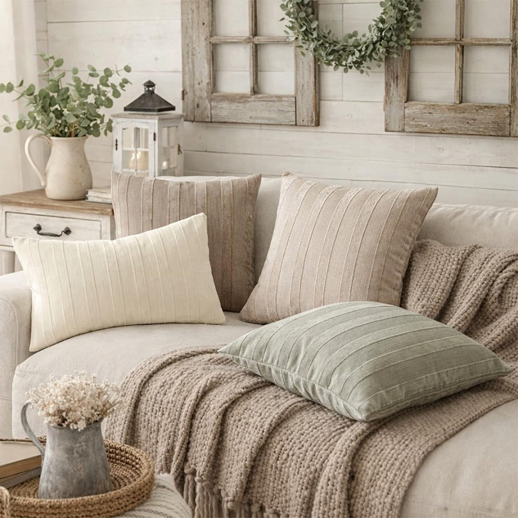 Beige striped throw pillow covers on a sofa, textured woven fabric