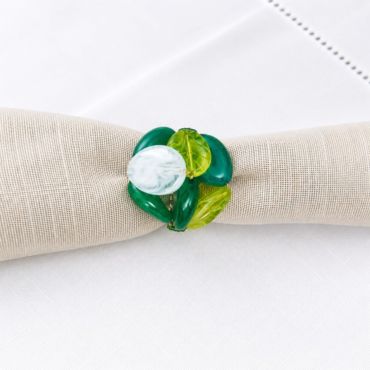 Green gemstone beaded napkin ring with turquoise, clear, and yellow oval stones on gold band