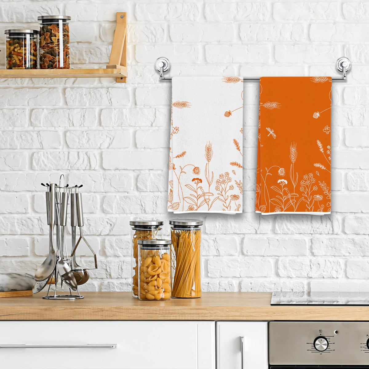 Set of two kitchen towels hanging on a rack, white and orange floral designs