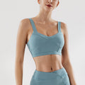 Dusty blue sports bra with matching high-waist underwear, front view.