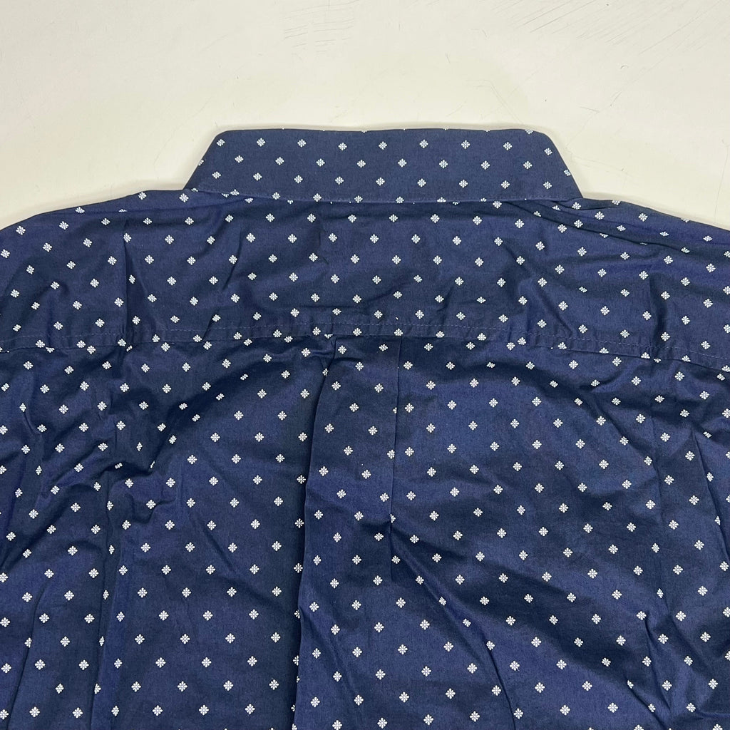 Navy shirt back with small white daisy pattern and stitched shoulder seam detail.
