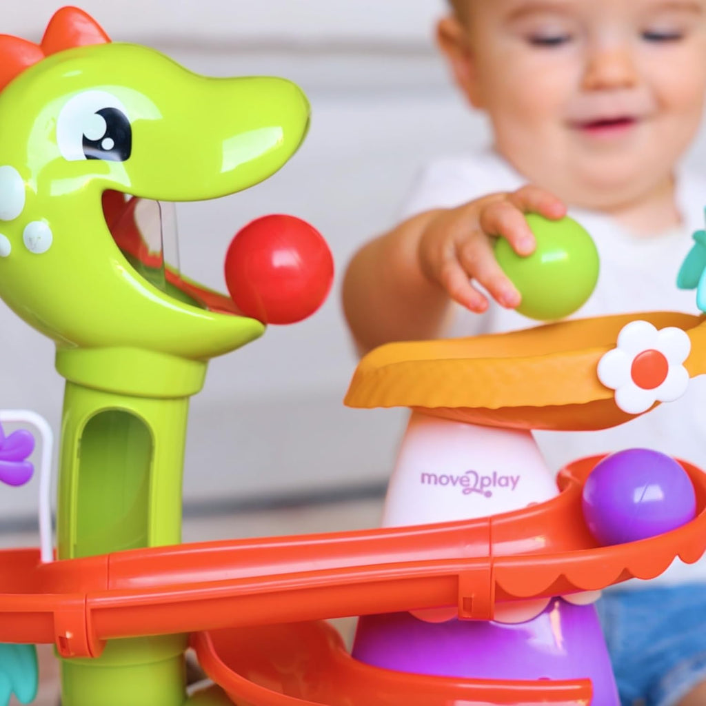 Close-up of air-powered dinosaur ball popper with red ball on orange track