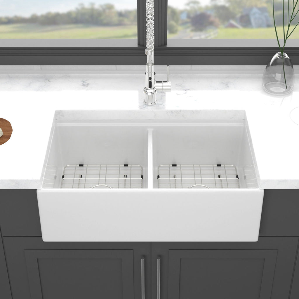 White ceramic double-basin sink showing interior divider and fitted rack inserts