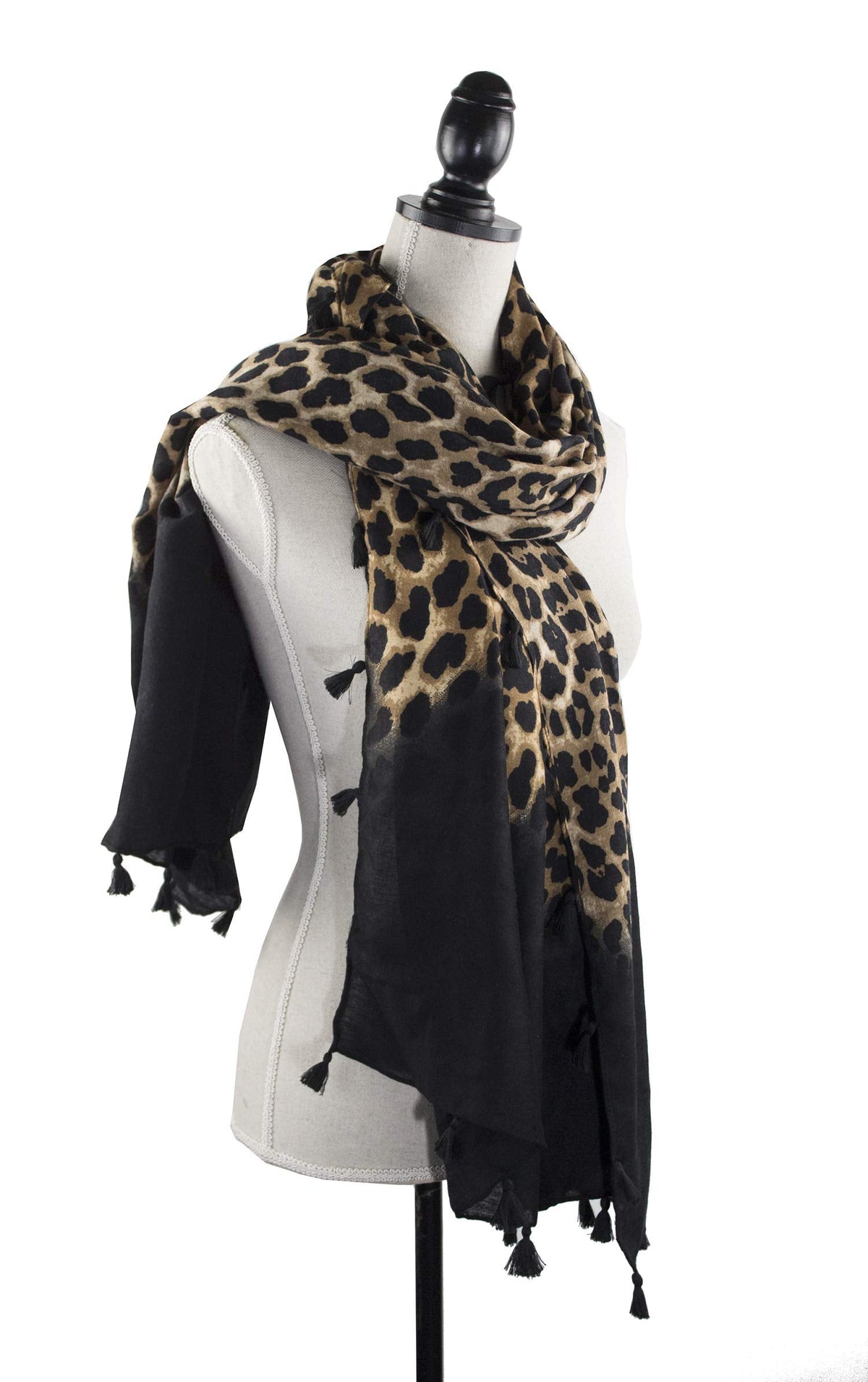 Leopard print scarf wrap with tassels, layered over a black sleeve.