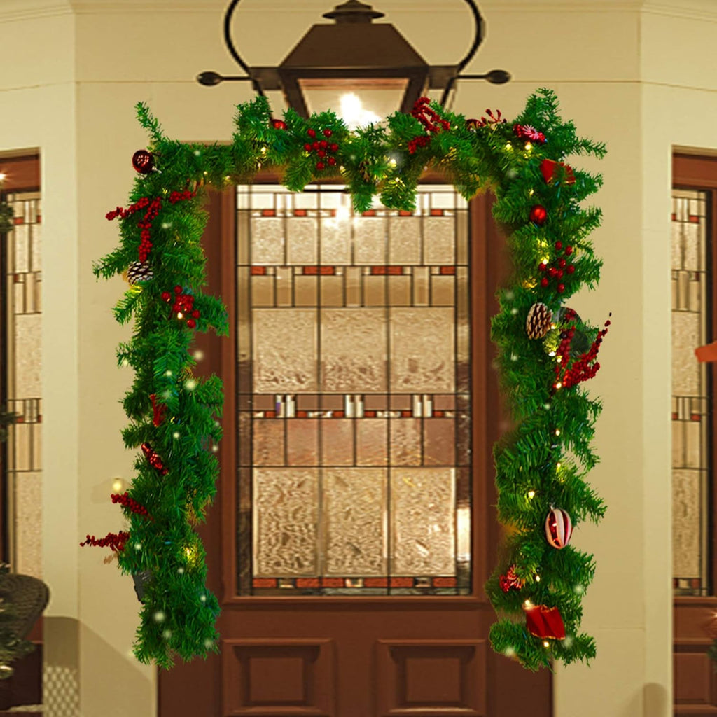Outdoor LED Christmas garland wreath-style loop with green pine tips, red ornaments, and warm bulbs