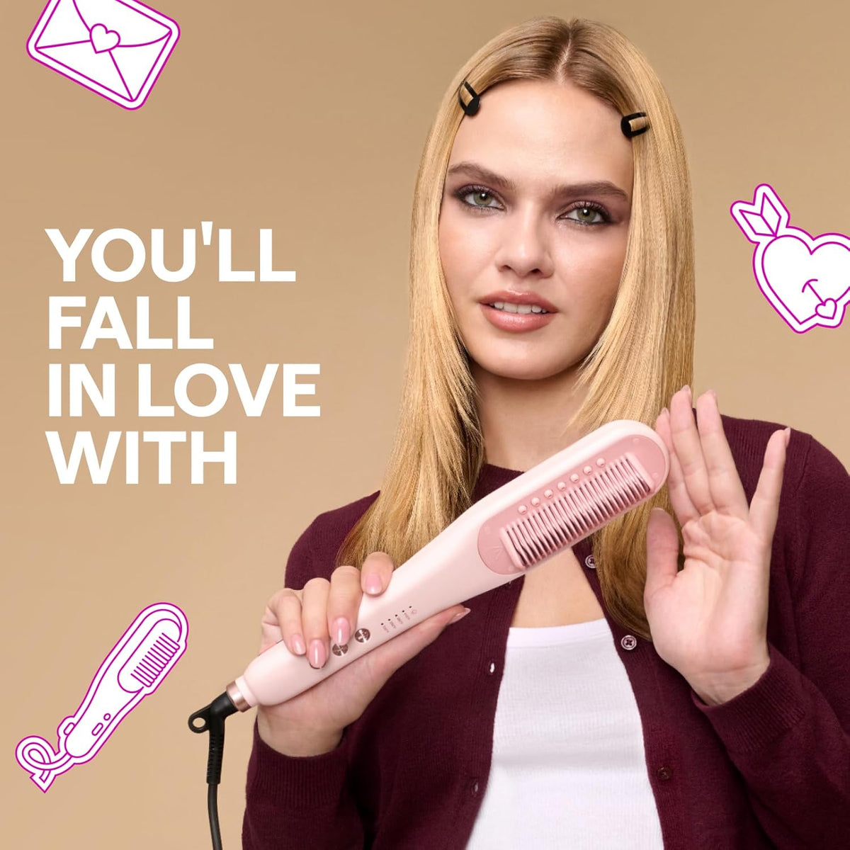 Pink steam hair straightener brush held in hand near long blonde hair