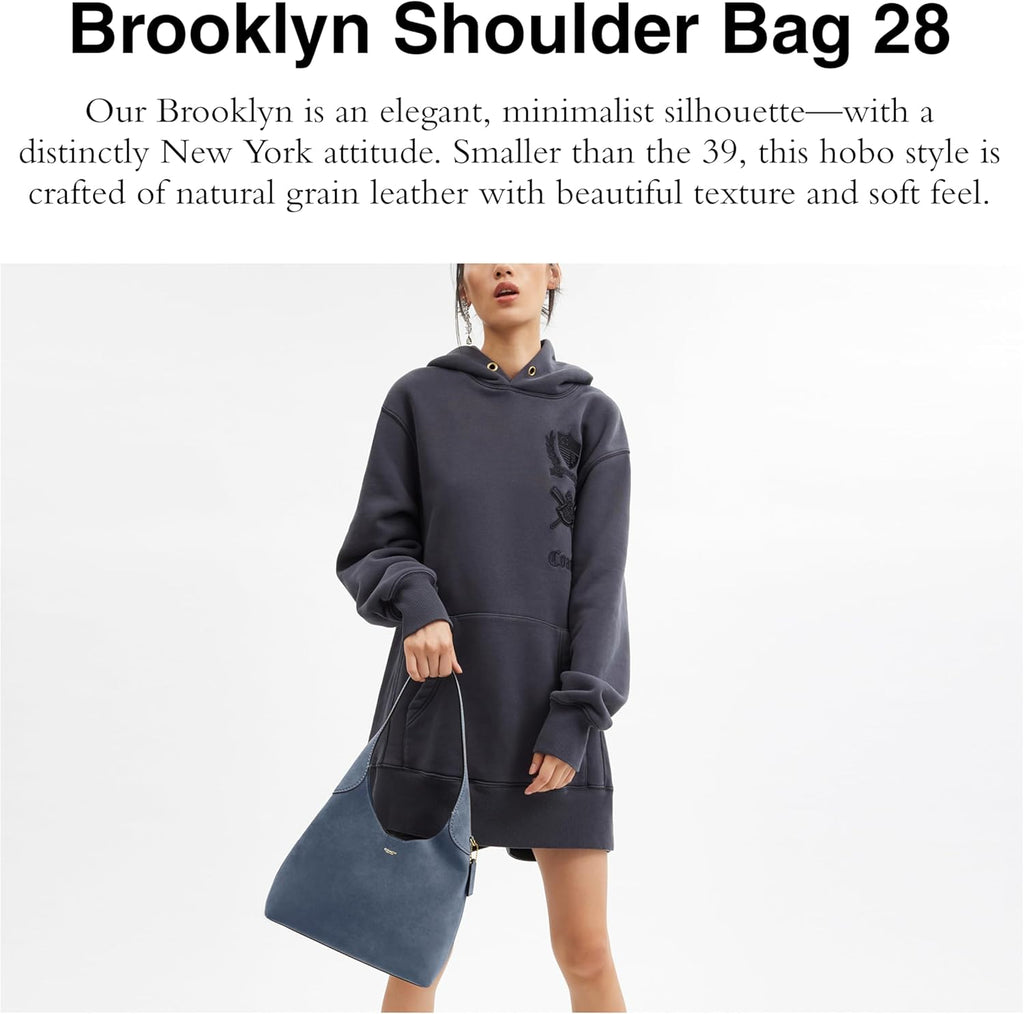Navy Brooklyn hobo shoulder bag with top handle and magnetic snap closure.