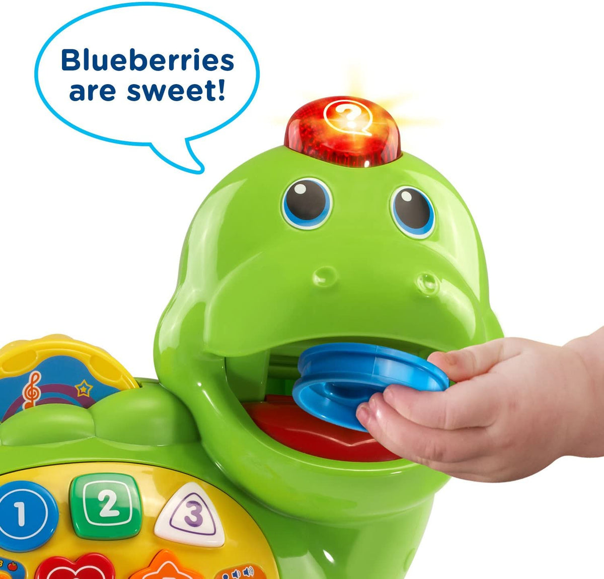 Close-up of green counting dinosaur toy with open mouth and blue feeding tray