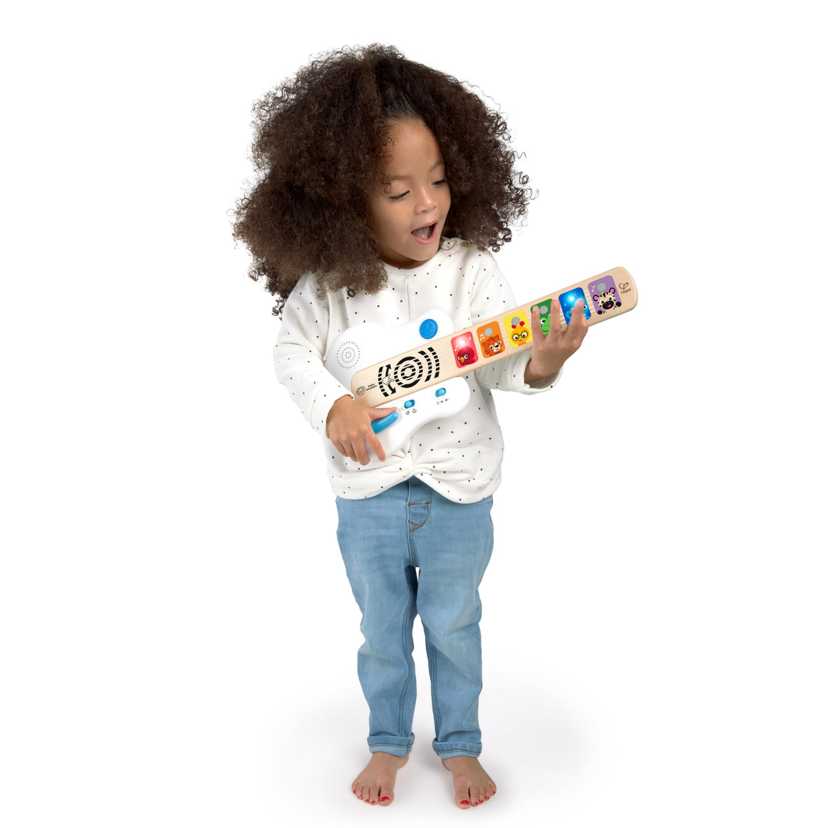 Child playing a light-up wooden guitar toy with colorful animal fretboard