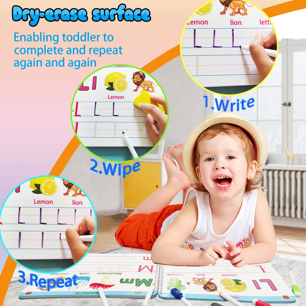 Toddler smiling while writing with a marker on a dry-erase learning surface.