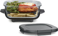 Glass meal container with dark lid, holding pasta and a chicken cutlet
