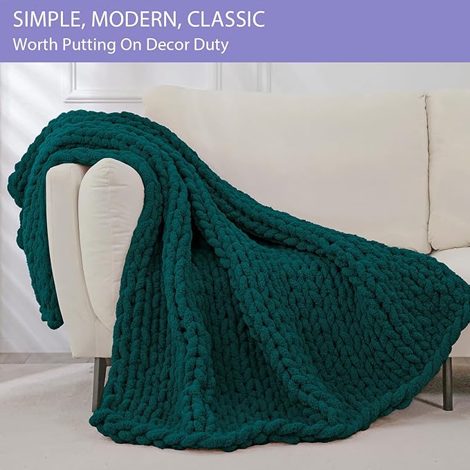 Dark green chunky knit throw blanket with rope-knot cable pattern draped over sofa