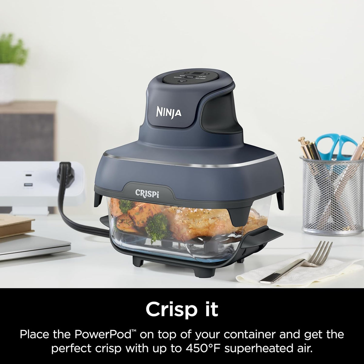 Glass 6-cup container with lid on a countertop, paired with a compact crisper base
