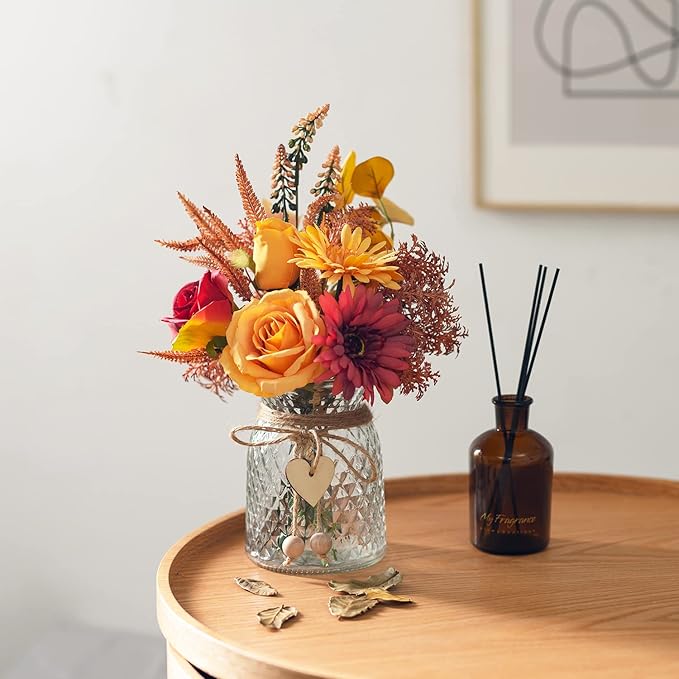 Faux flower arrangement in textured glass vase with heart charm and decorative twine ribbon