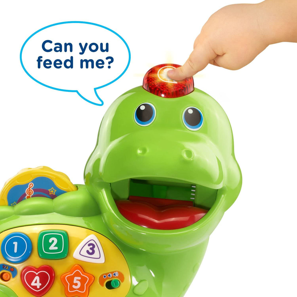 Green counting dinosaur toy with glowing dome top and open mouth, hand holding a food piece