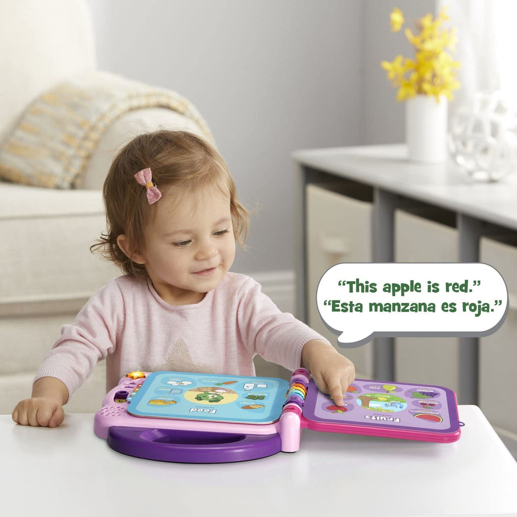 Toddler holding bilingual words book toy on table, purple and pink case with buttons