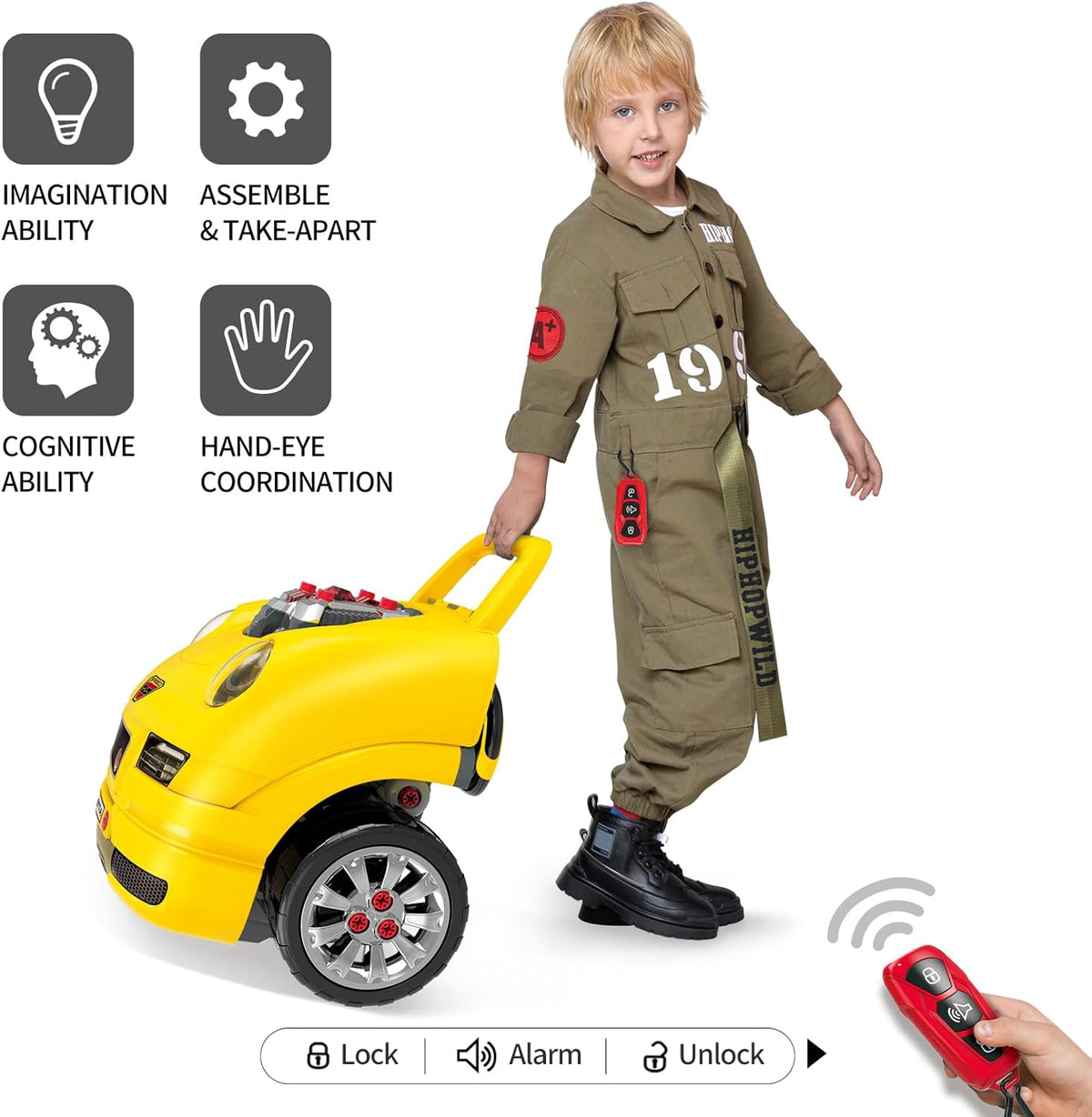 Toddler playing with yellow toy mechanic truck, wearing jumpsuit, holding remote control