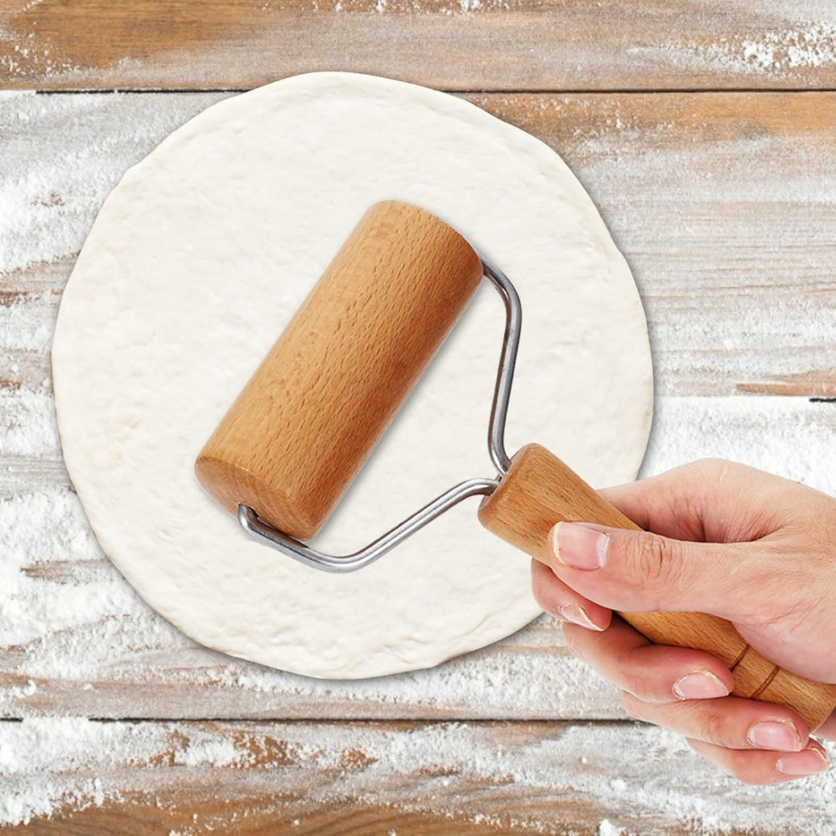 Wooden tortilla rolling pin with U-shaped metal handles pressing dough