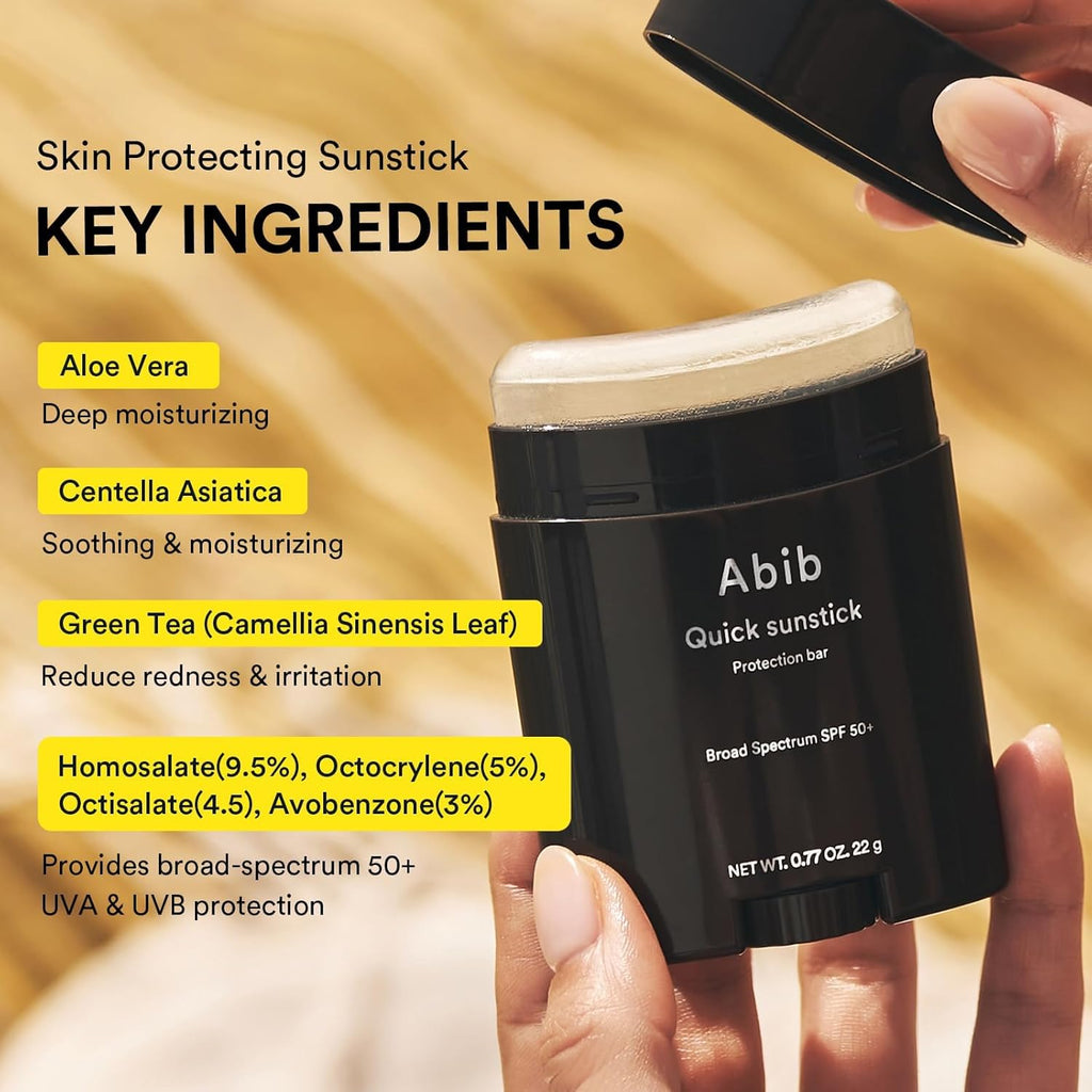 Abib quick sunstick SPF50+ in black container held by fingers