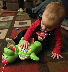 Green baby dinosaur activity toy with numbered buttons