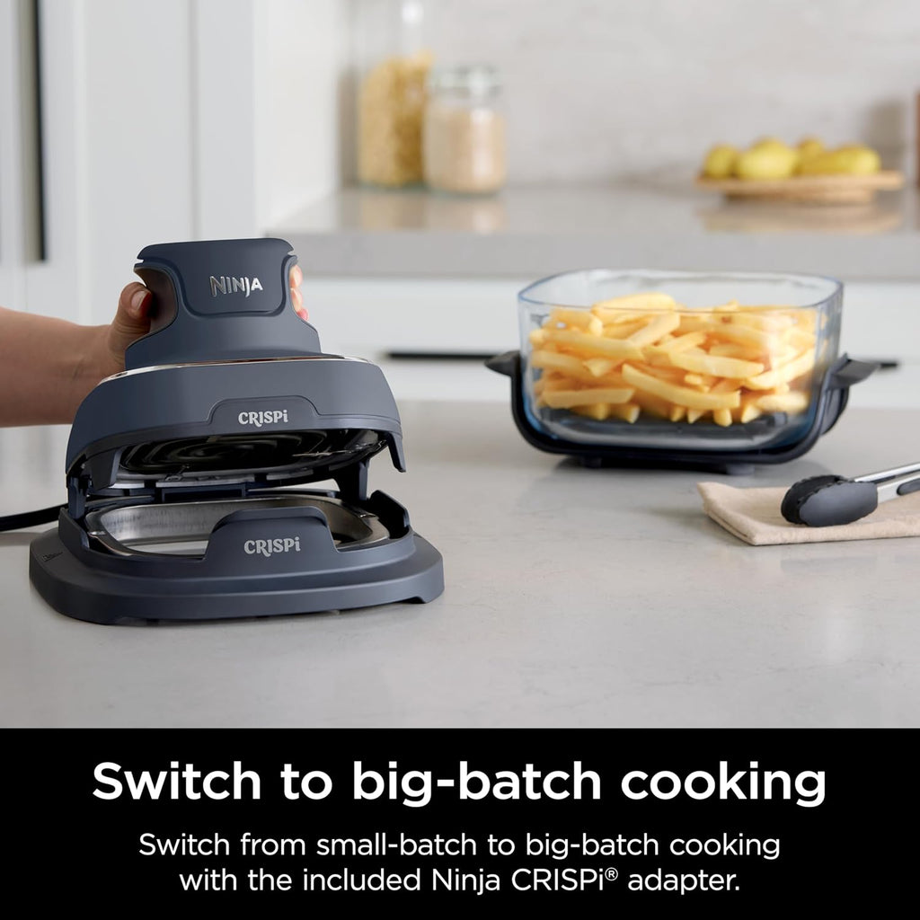 Compact air fryer base with clear glass drawer-style container of fries