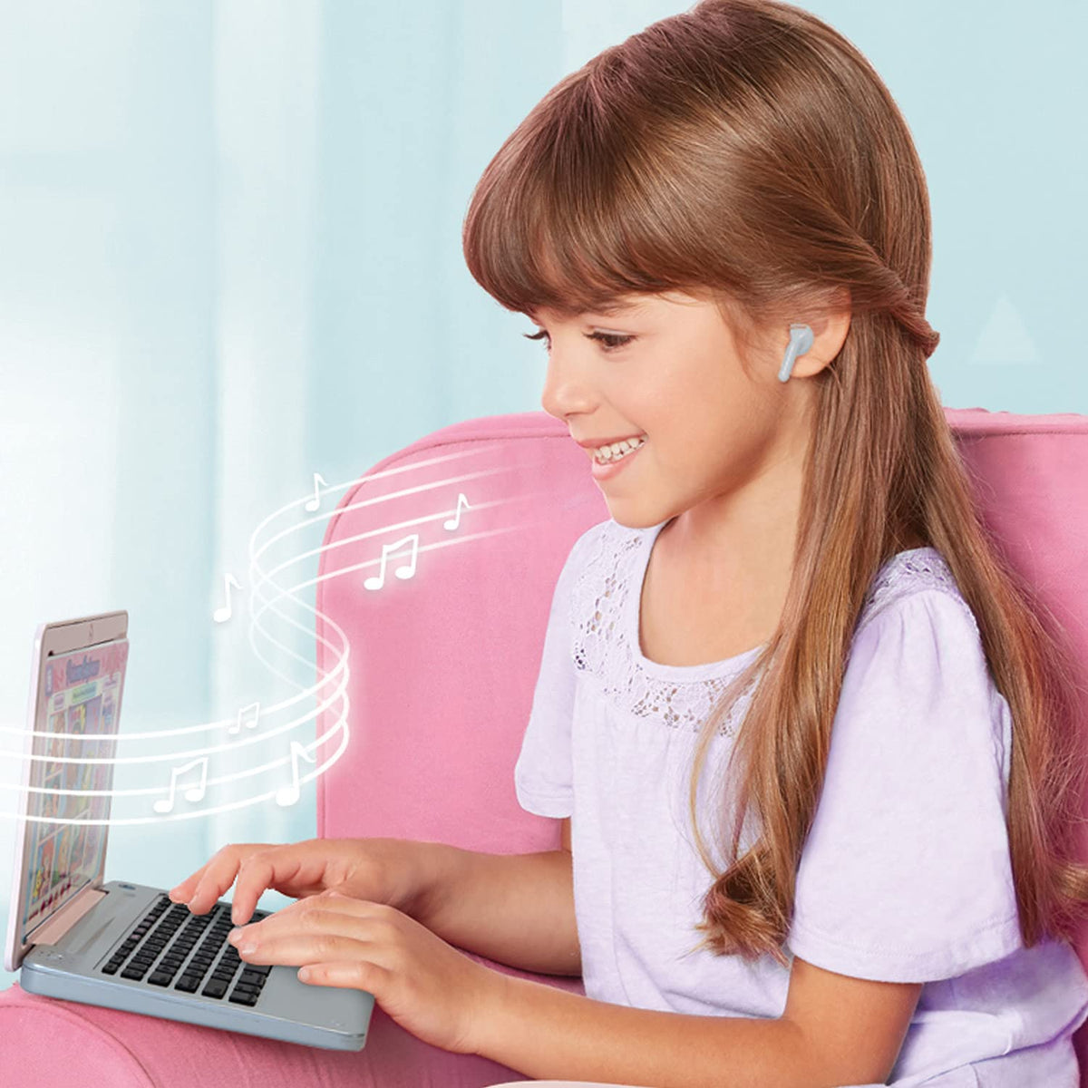 Kids laptop with open screen and black keyboard, shown from the side with music icons